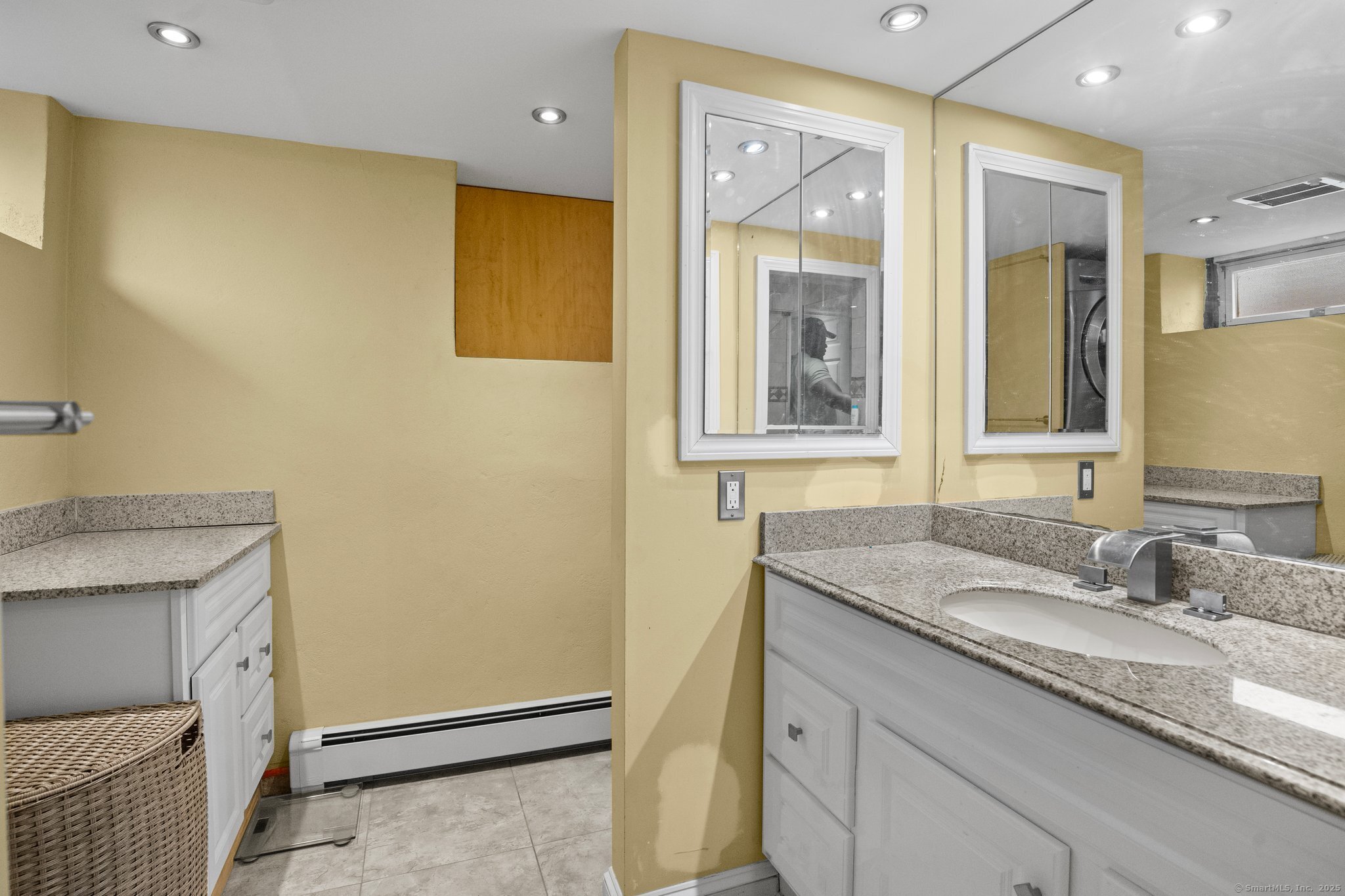 15 Overland Avenue Bridgeport, CT 06606 - Photo 11 of 35 a bathroom with a granite countertop sink and a mirror
