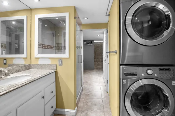 a bathroom with a granite countertop sink and a mirror
