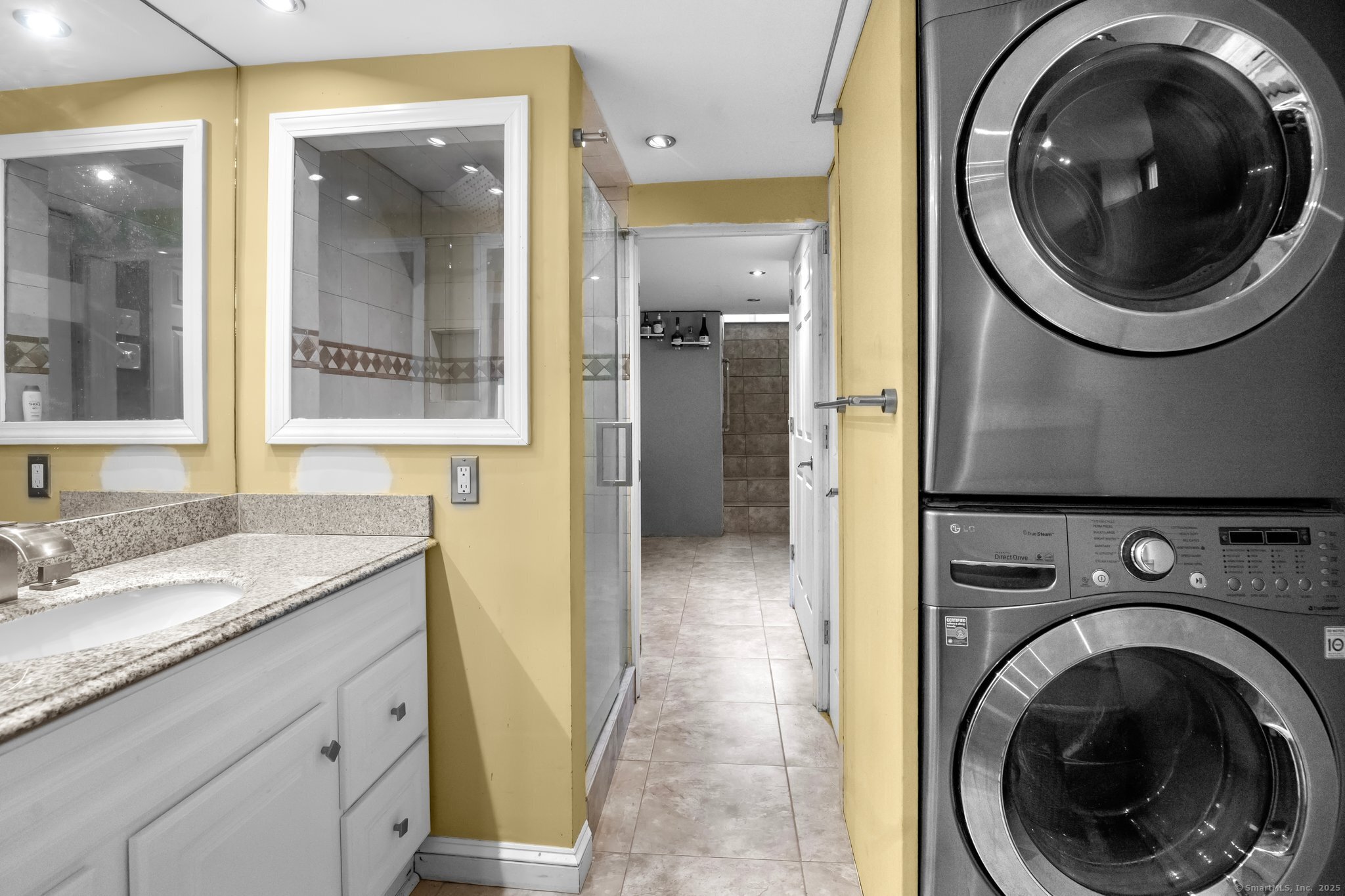 15 Overland Avenue Bridgeport, CT 06606 - Photo 12 of 35 a bathroom with a granite countertop sink and a mirror