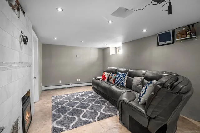 a living room with furniture and a fireplace