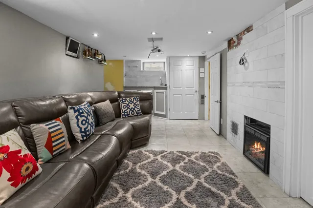 a living room with furniture and a fireplace