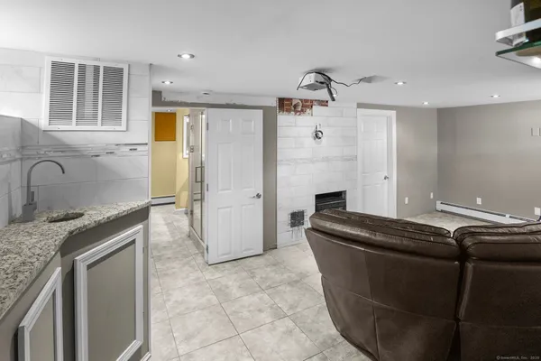 a kitchen with granite countertop a sink and a refrigerator