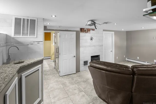 a kitchen with granite countertop a sink and a refrigerator