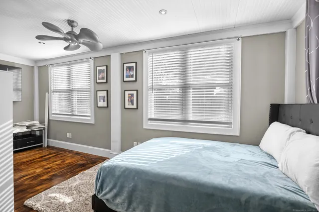 a bedroom with a large bed and a window