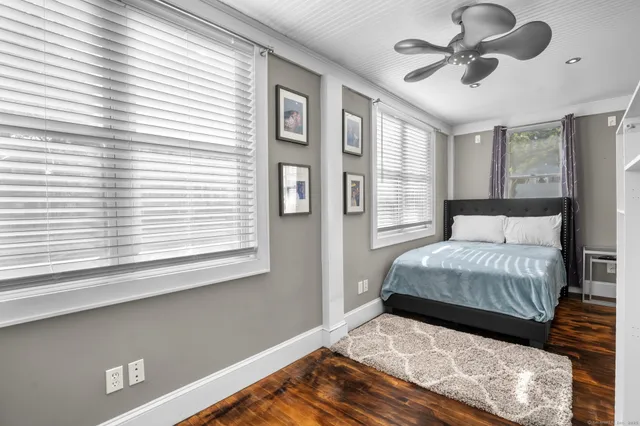 a bedroom with a large bed and a large window