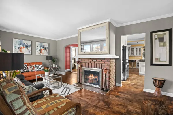 a living room with furniture a window and a fireplace