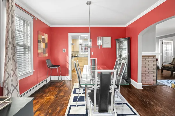 a view of a dining room with furniture and wooden floor