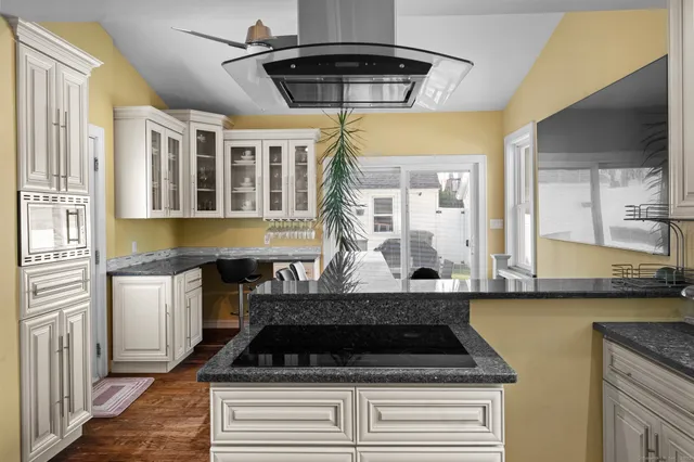 a kitchen that has a stove and a table