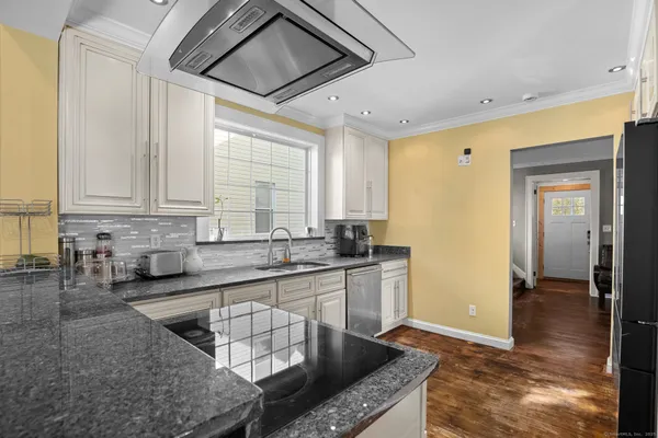 a kitchen with stainless steel appliances granite countertop a sink and cabinets