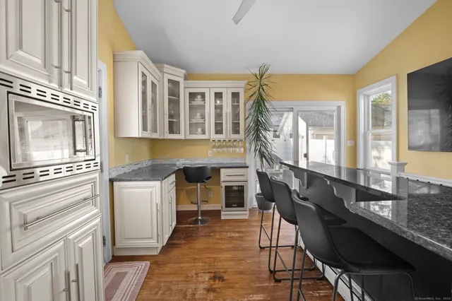 a view of a kitchen with granite countertop a table and chairs in it