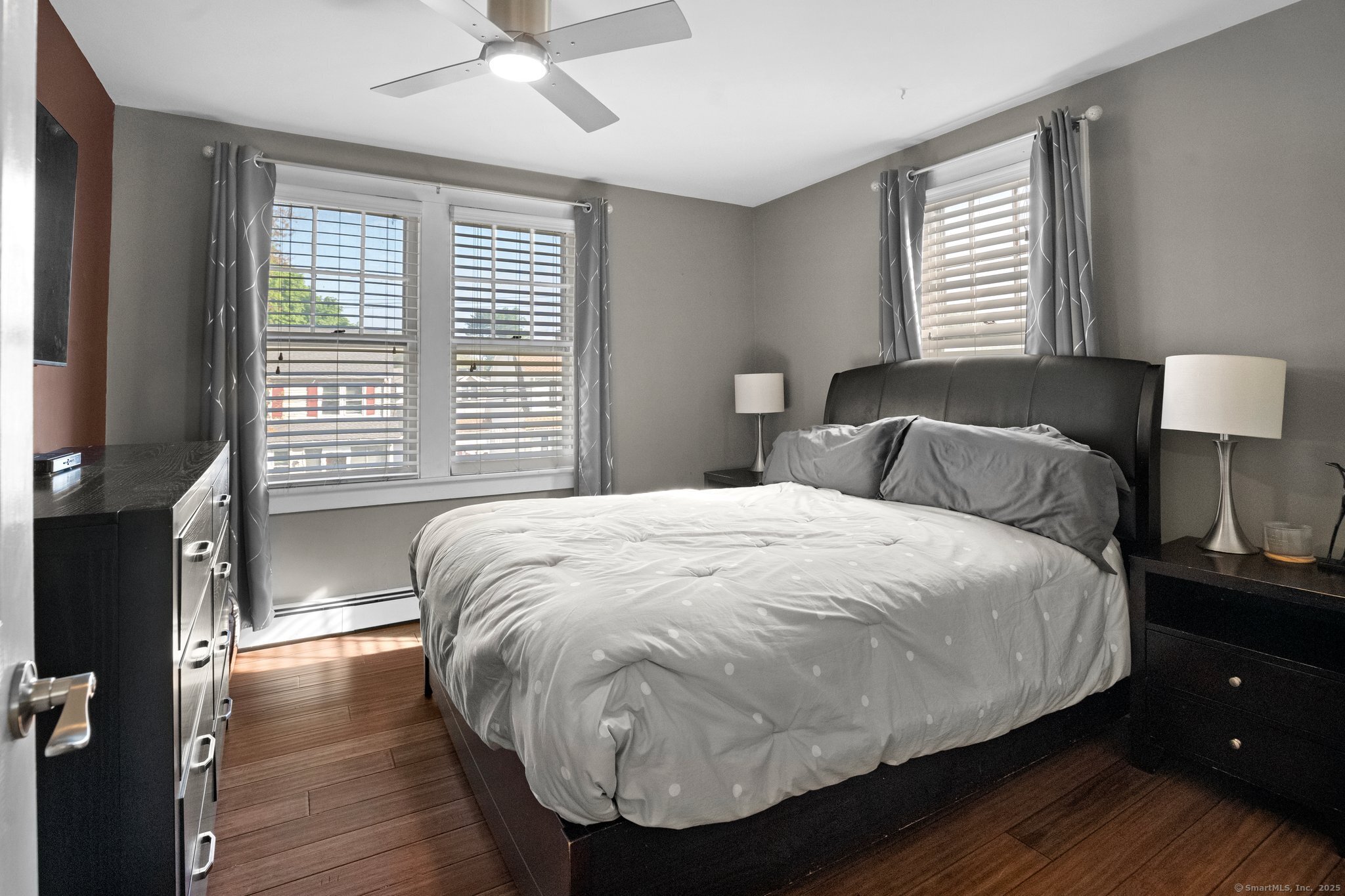 15 Overland Avenue Bridgeport, CT 06606 - Photo 32 of 35 a large bed sitting in a bedroom next to a window and a chandelier