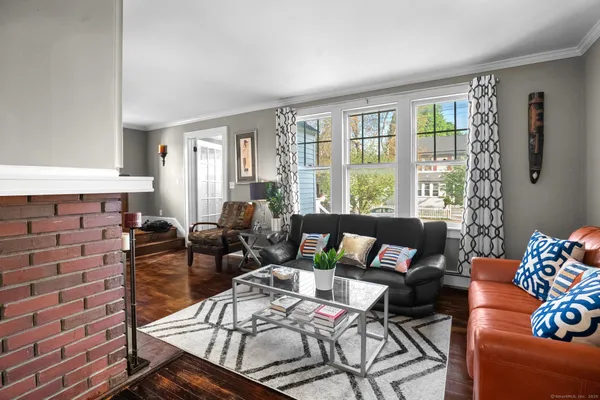 a living room with furniture and a floor to ceiling window