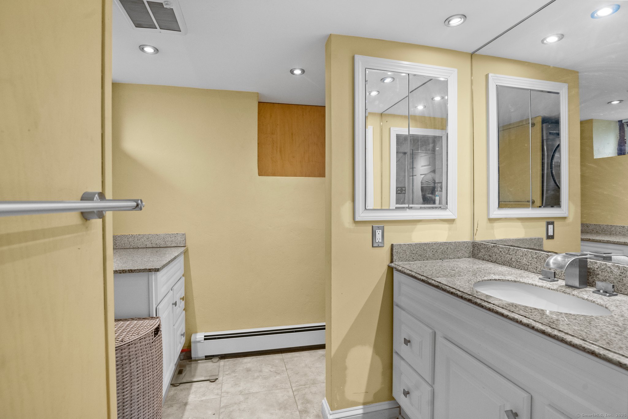 15 Overland Avenue Bridgeport, CT 06606 - Photo 10 of 35 a bathroom with a granite countertop sink and a mirror