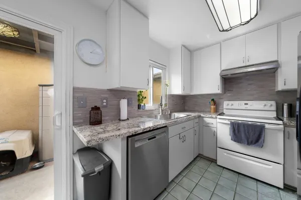 a kitchen with a sink stove and cabinets