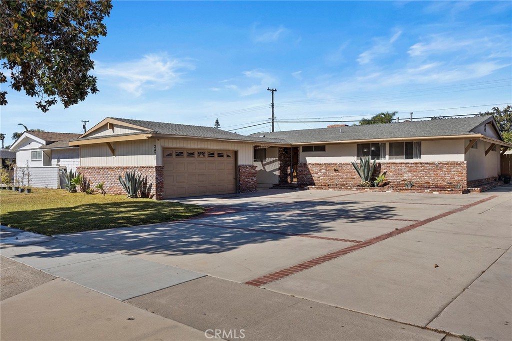 2471 West Chanticleer Road Anaheim, CA 92804 - Photo 1 of 1 a front view of a house with a yard and garage