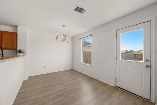 a kitchen with refrigerator and table