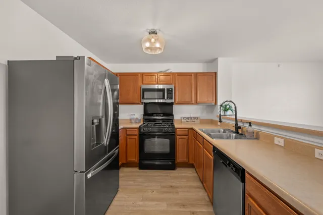 a kitchen with sink and wooden floor