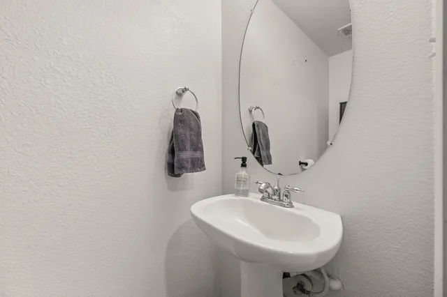 a spacious bedroom with a bed and a chandelier