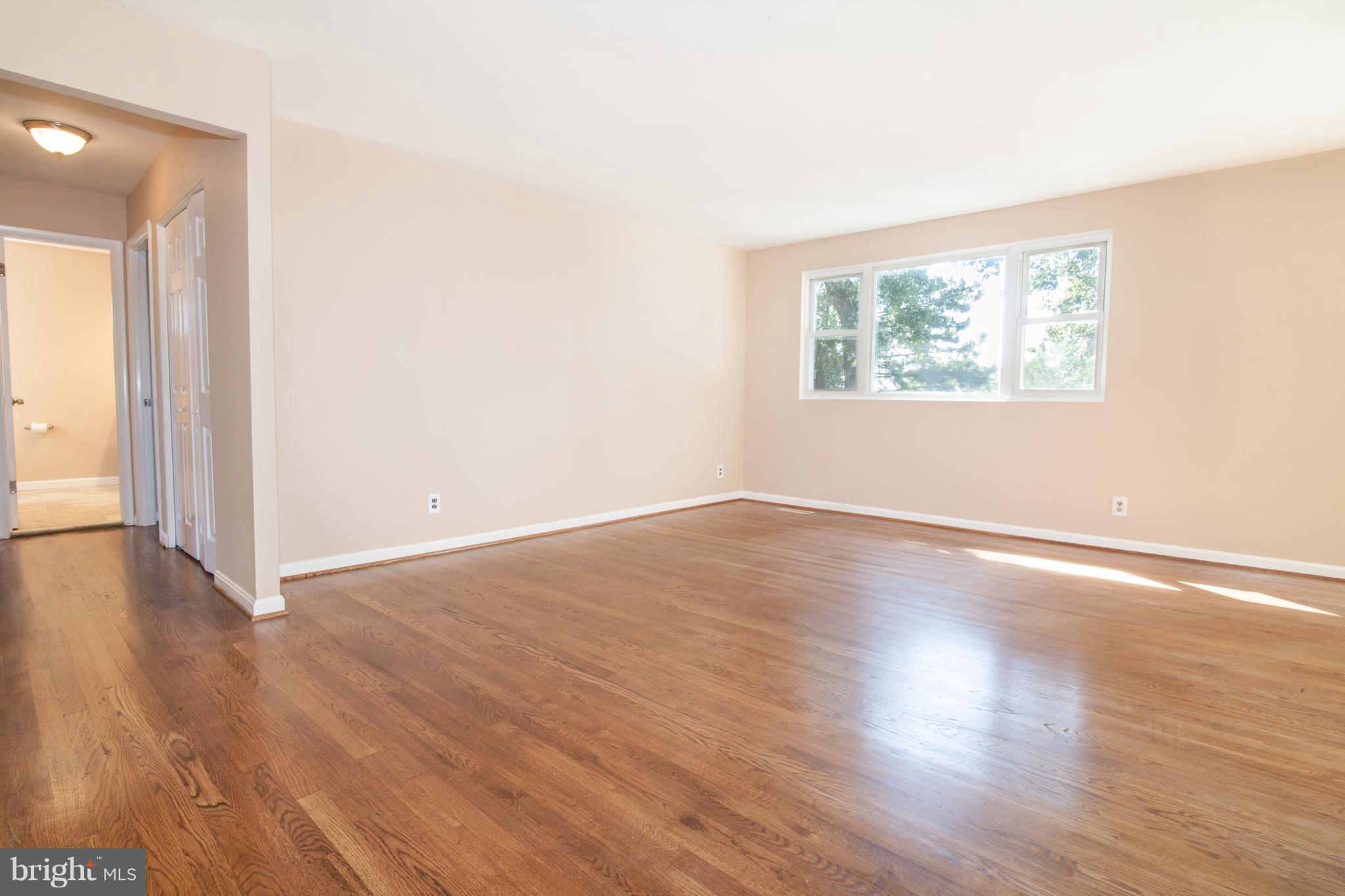 4423 Fieldgreen Road Baltimore, MD 21236 - Photo 14 of 35 an empty room with wooden floor and windows