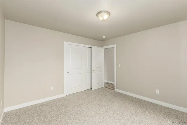 an empty room with closet area