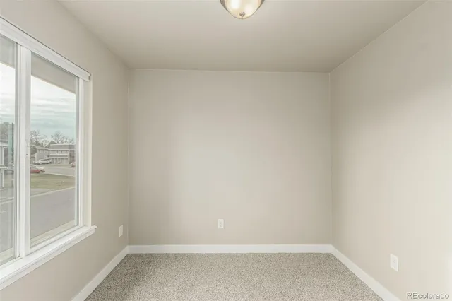 a view of a hallway with wooden floor and closet