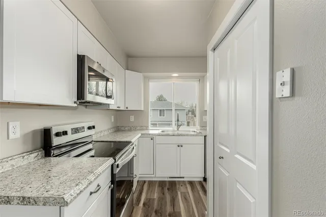 a kitchen with a sink stove and refrigerator