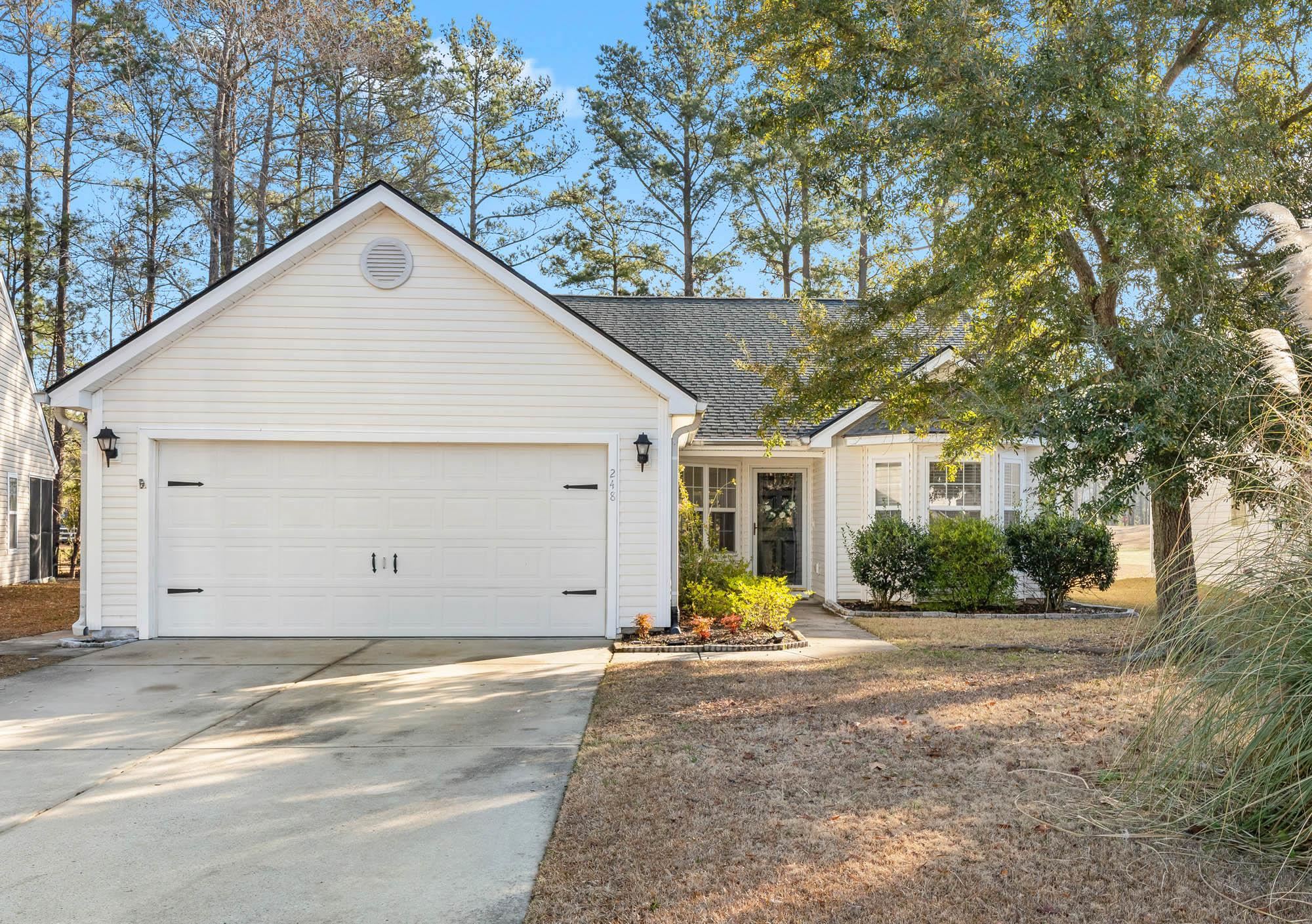 248 McKendree Lane Myrtle Beach, SC 29579 - Photo 1 of 34 View of front facade with driveway, roof with shingles, and an attached garage