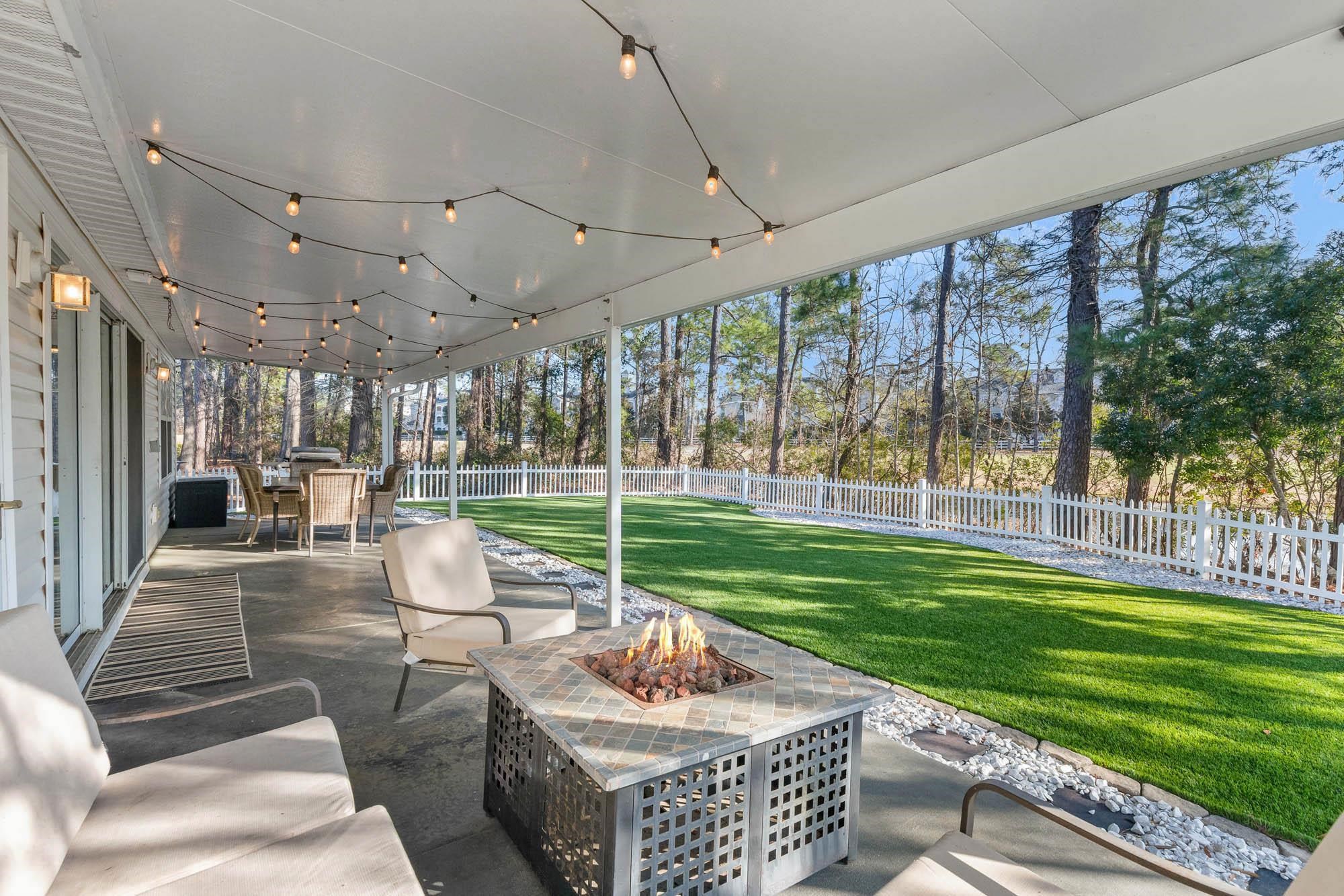 248 McKendree Lane Myrtle Beach, SC 29579 - Photo 20 of 34 Fenced backyard with a patio area, outdoor dining space, and an outdoor living space with a fire pit