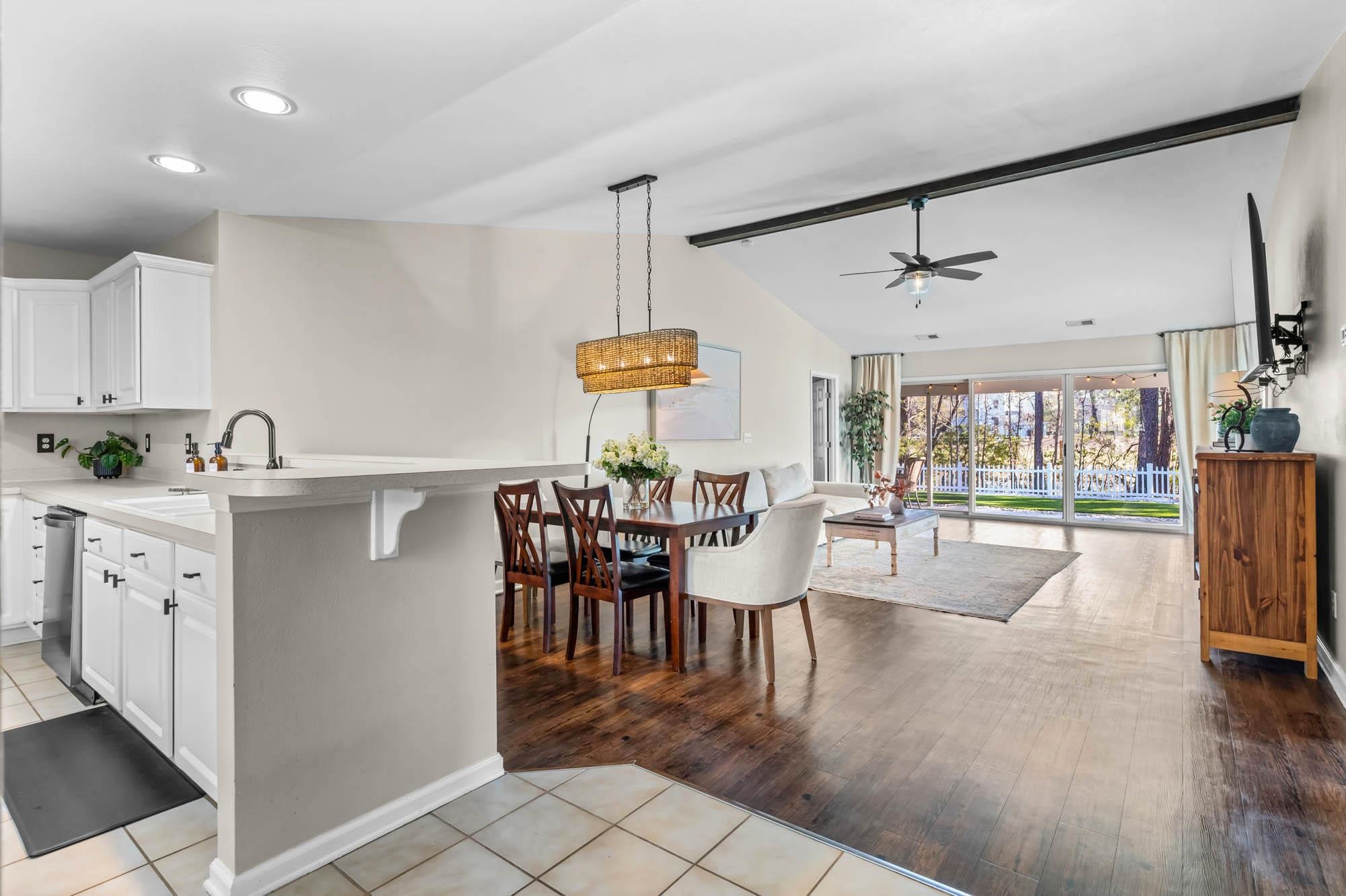 248 McKendree Lane Myrtle Beach, SC 29579 - Photo 2 of 34 Kitchen with white cabinets, light countertops, a kitchen bar, light tile patterned floors, and pendant lighting