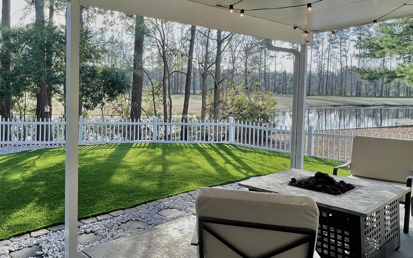 248 McKendree Lane Myrtle Beach, SC 29579 - Photo 21 of 34 Fenced backyard with a patio area, a fire pit, and a water view