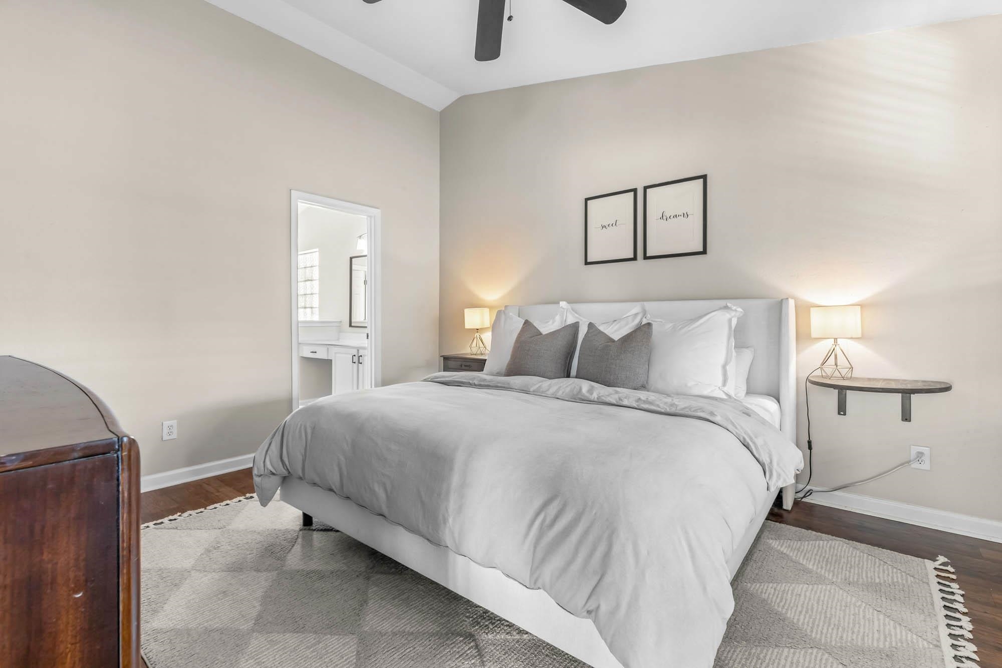 248 McKendree Lane Myrtle Beach, SC 29579 - Photo 24 of 34 Bedroom with connected bathroom, lofted ceiling, wood finished floors, and ceiling fan