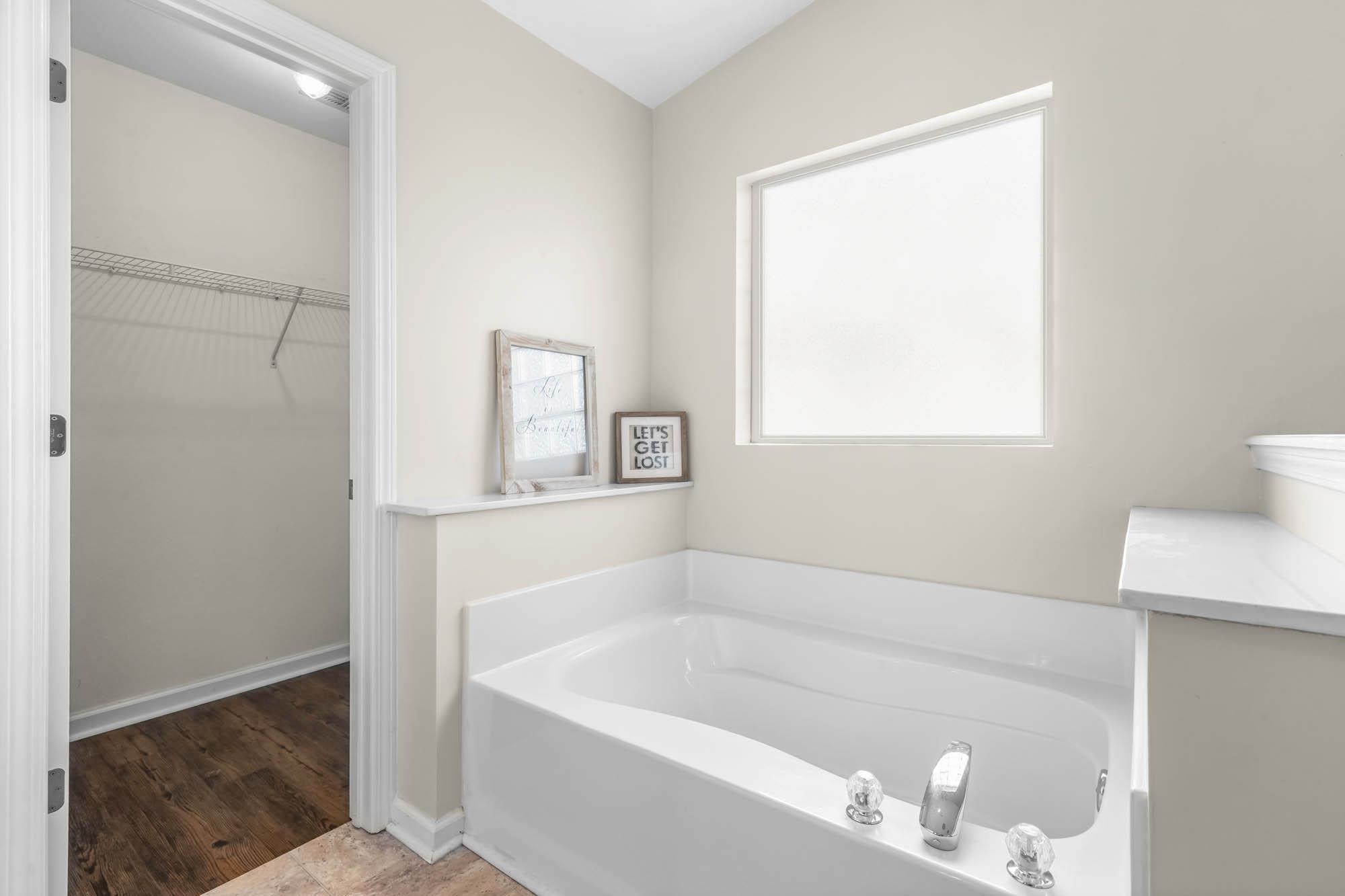 248 McKendree Lane Myrtle Beach, SC 29579 - Photo 31 of 34 Bathroom featuring a walk in closet, a bath, and light wood finished floors