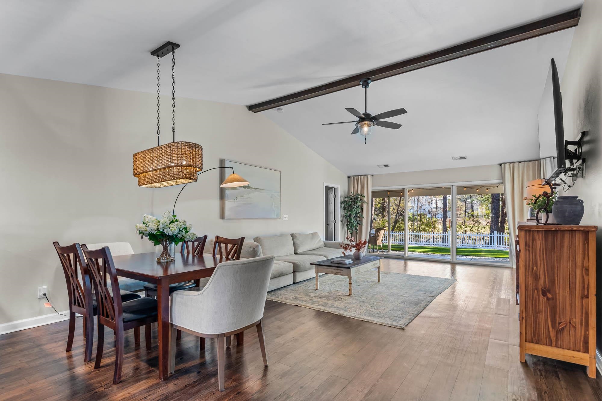248 McKendree Lane Myrtle Beach, SC 29579 - Photo 7 of 34 Dining room featuring beam ceiling, dark wood finished floors, high vaulted ceiling, and a ceiling fan