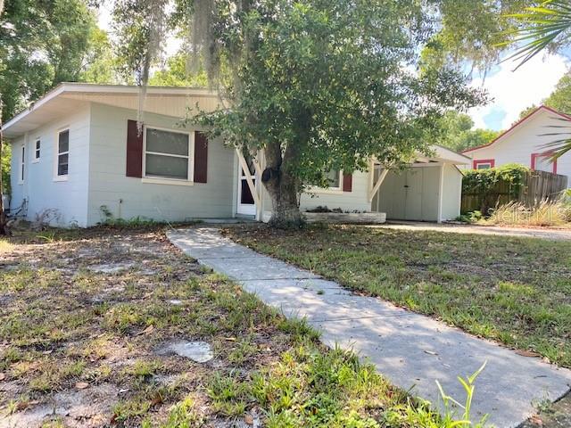 a white house that has a tree in front of it