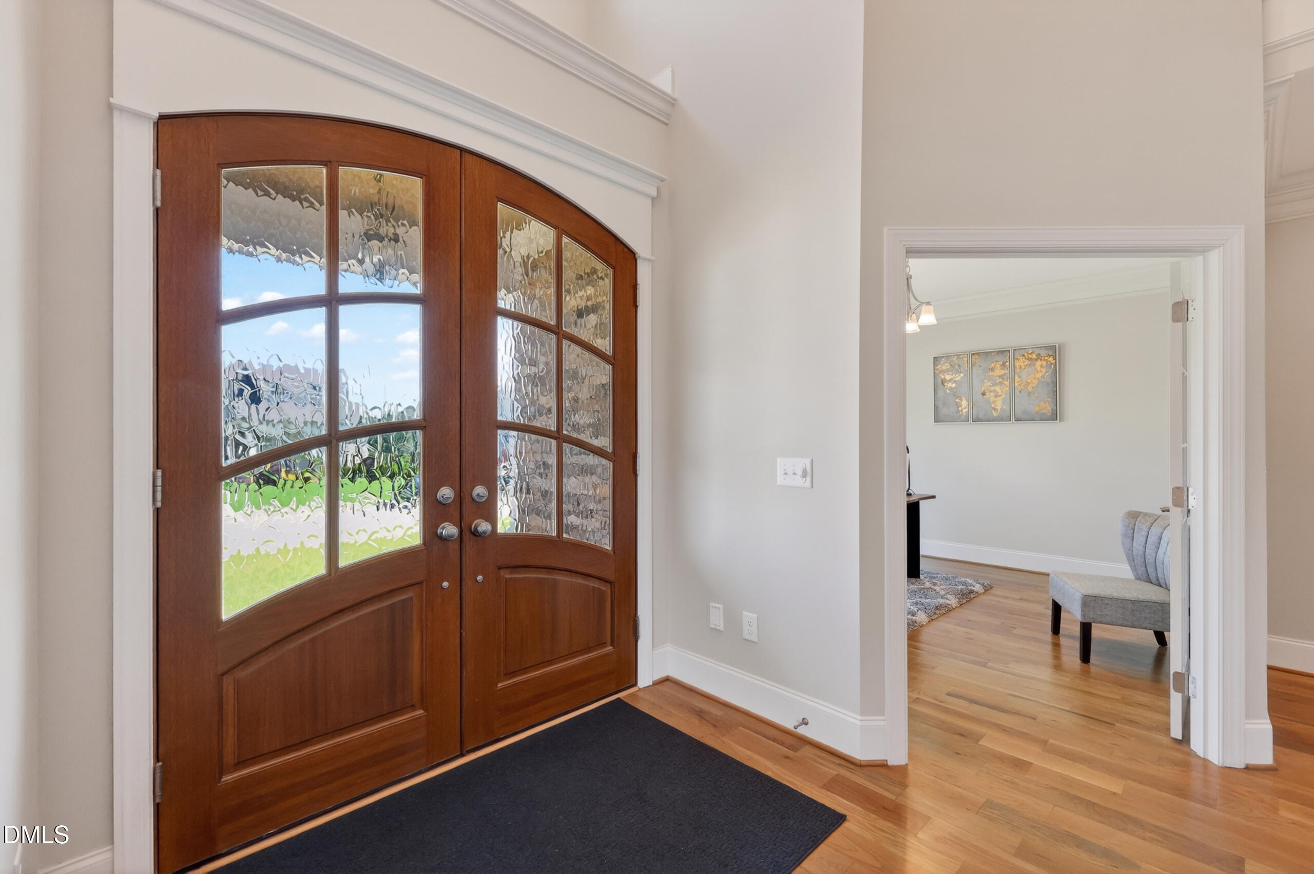 261 Character Drive Rolesville, NC 27571 - Photo 9 of 77 a view of a hallway with a large window and wooden floor