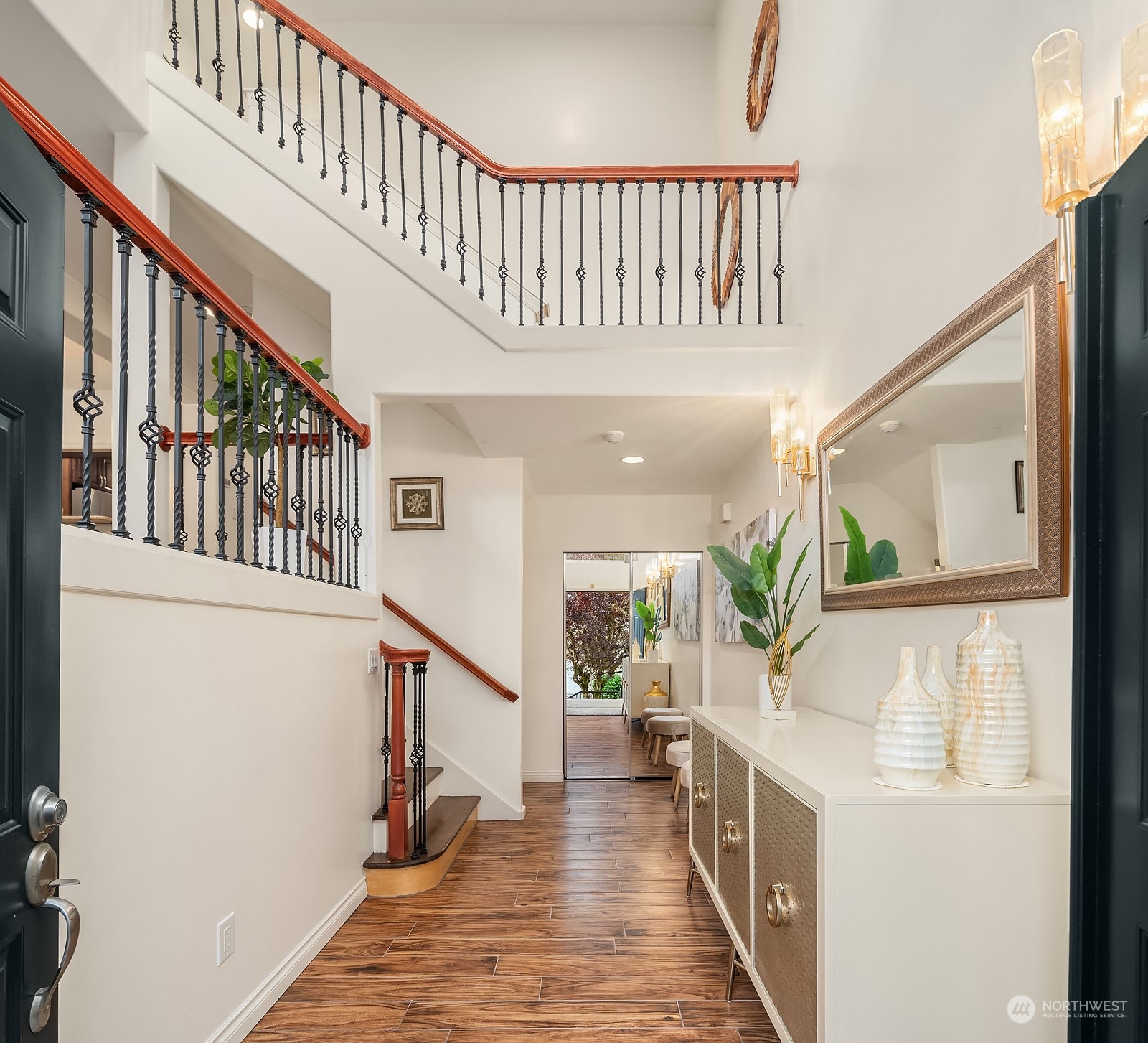 7323 Old Redmond Road, Unit 16 Redmond, WA 98052 - Photo 2 of 26 a view of staircase with lots of frames on wall and wooden floor