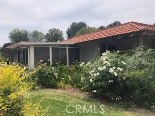 a front view of house with a garden