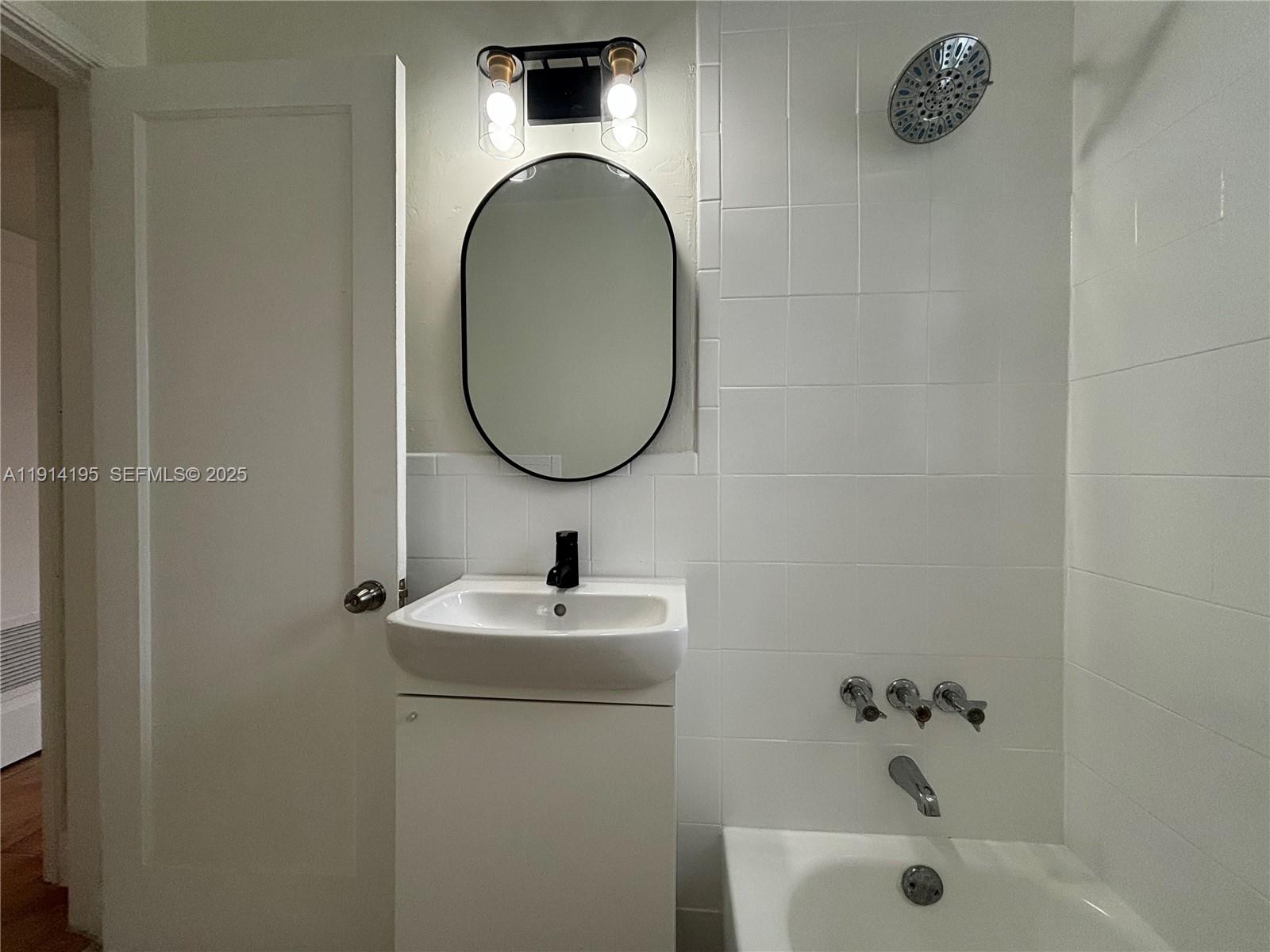 111 Southwest 31st Court, Unit 2 Miami, FL 33135 - Photo 4 of 11 a bathroom with a sink and a mirror
