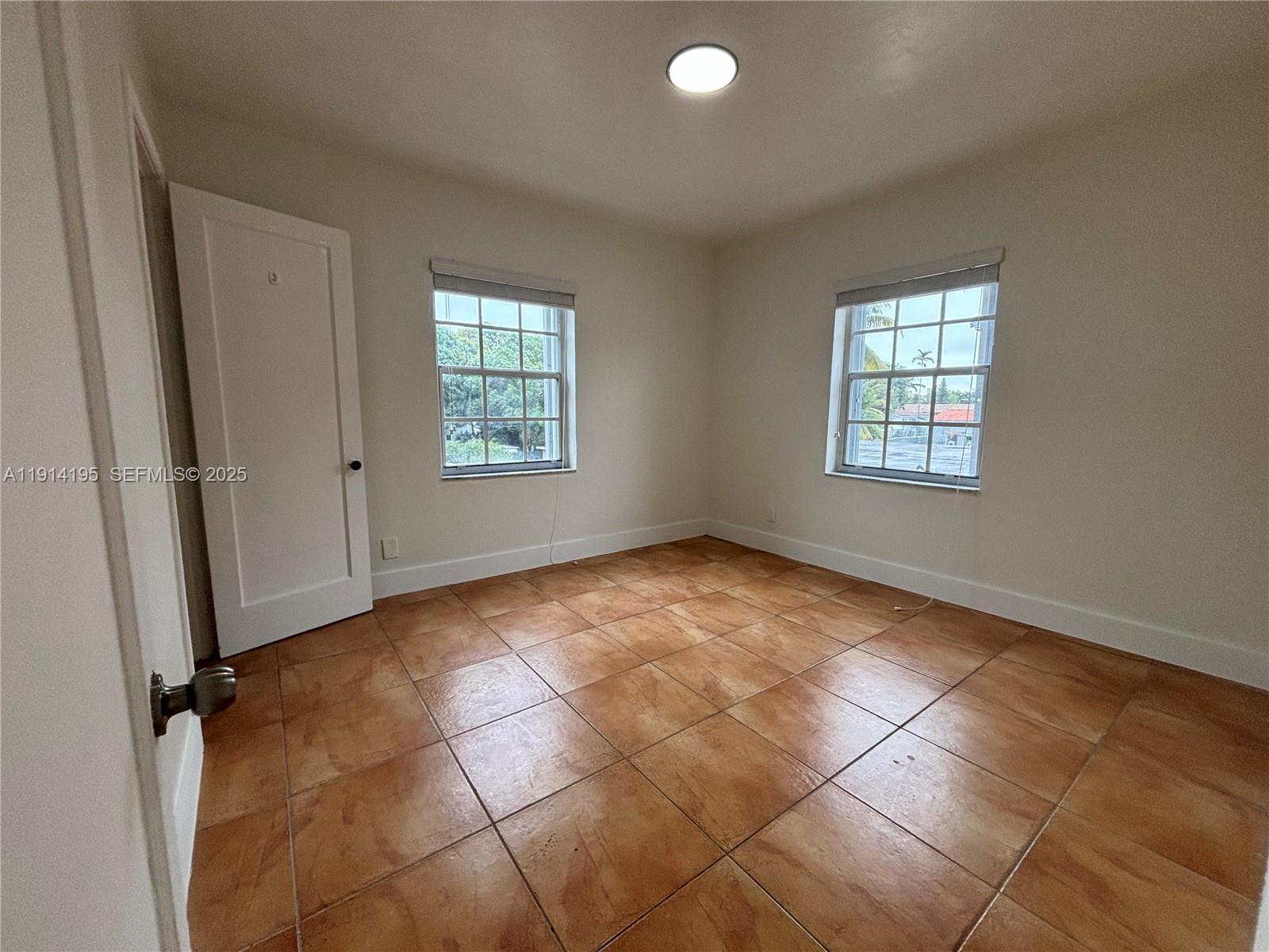 111 Southwest 31st Court, Unit 2 Miami, FL 33135 - Photo 5 of 11 an empty room with windows