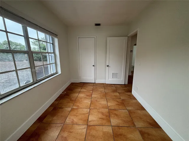 a view of an empty room and window