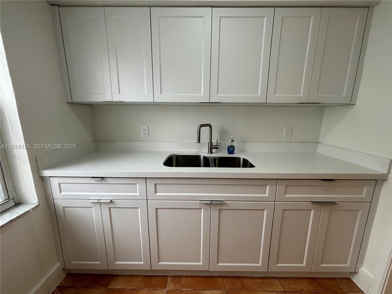 111 Southwest 31st Court, Unit 2 Miami, FL 33135 - Photo 9 of 11 a kitchen with white cabinets and white appliances
