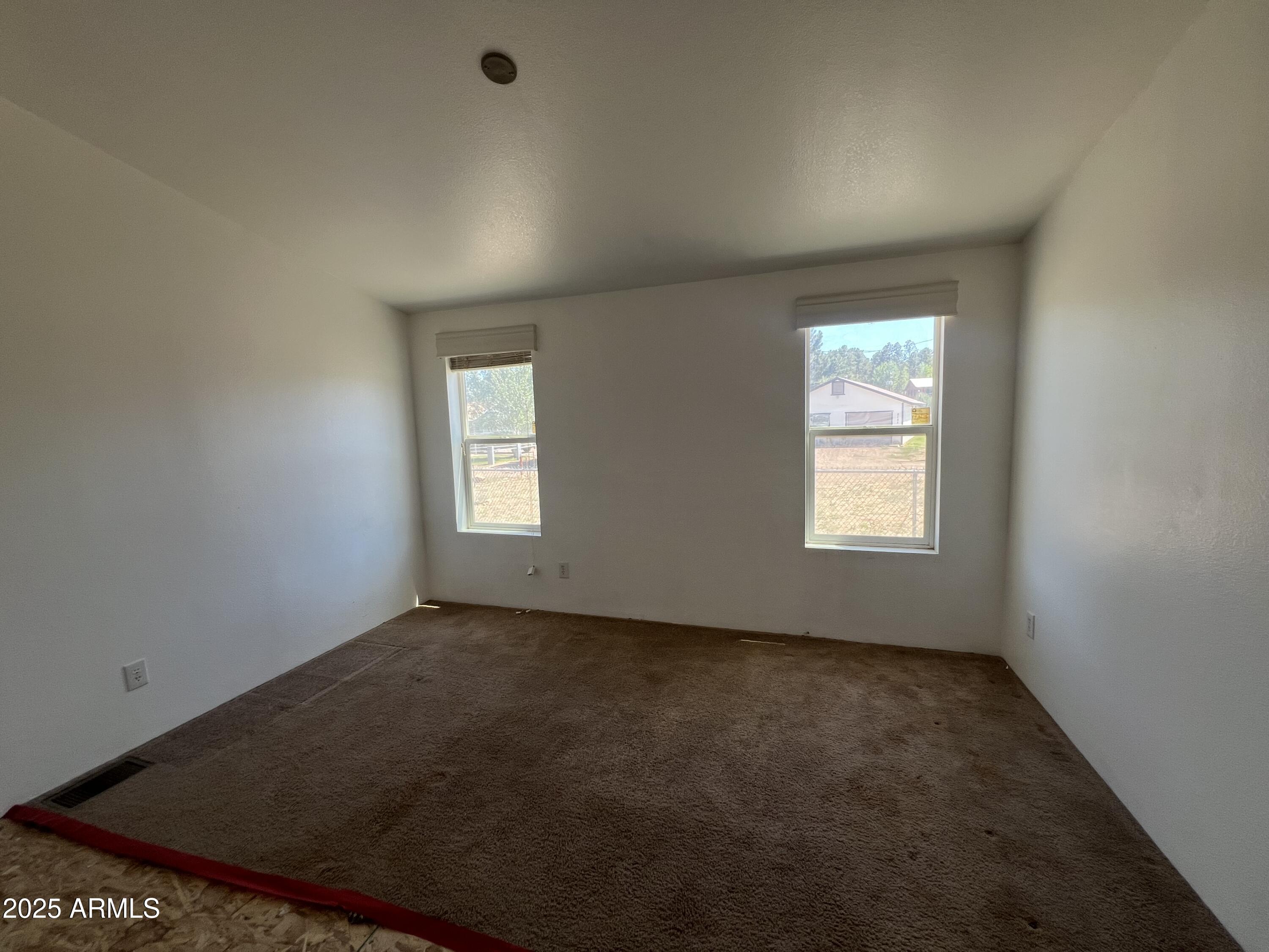 2122 Meadow Lane Overgaard, AZ 85933 - Photo 15 of 19 an empty room with windows