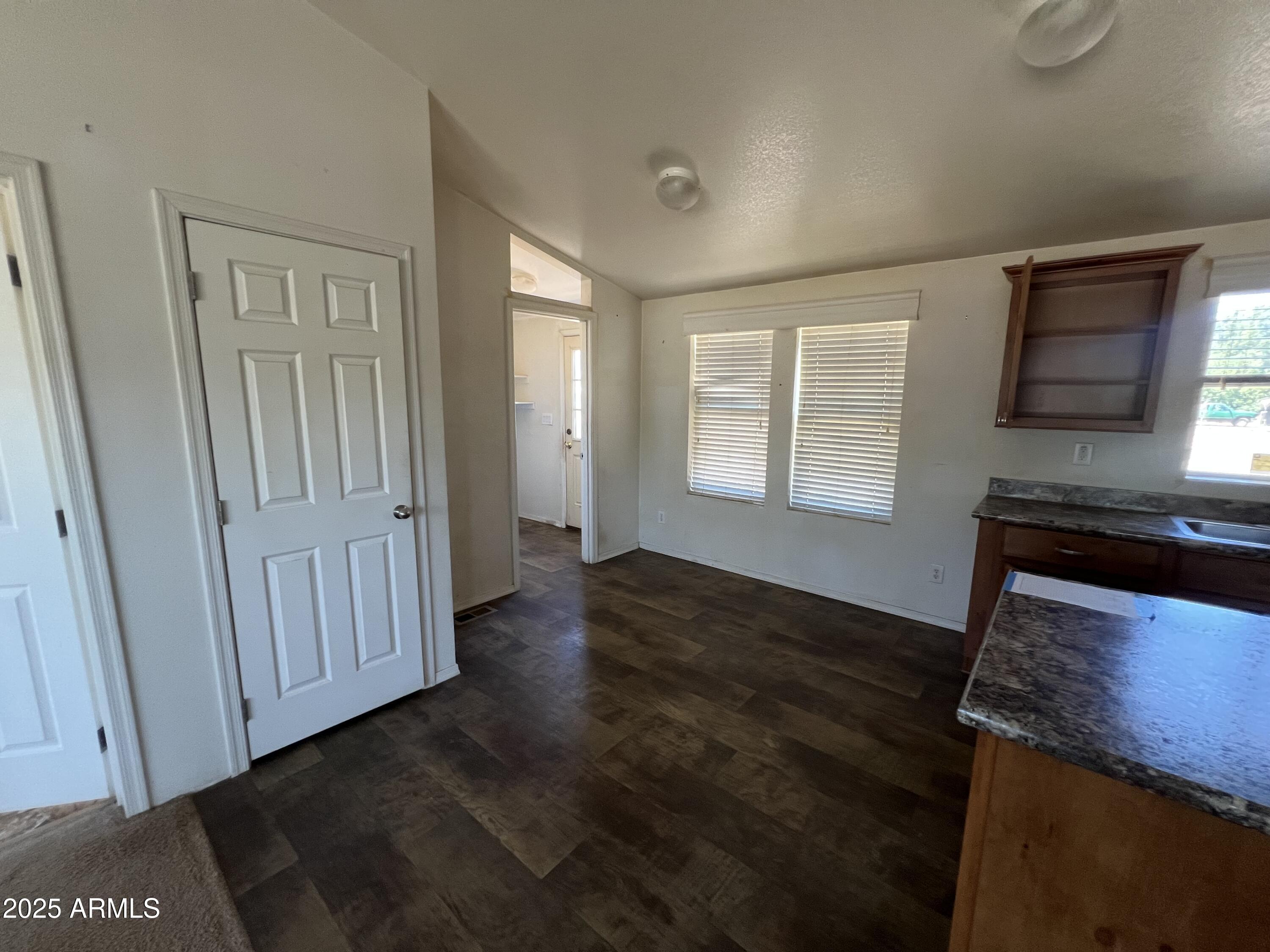 2122 Meadow Lane Overgaard, AZ 85933 - Photo 3 of 19 a view of an empty room with wooden floor and a window