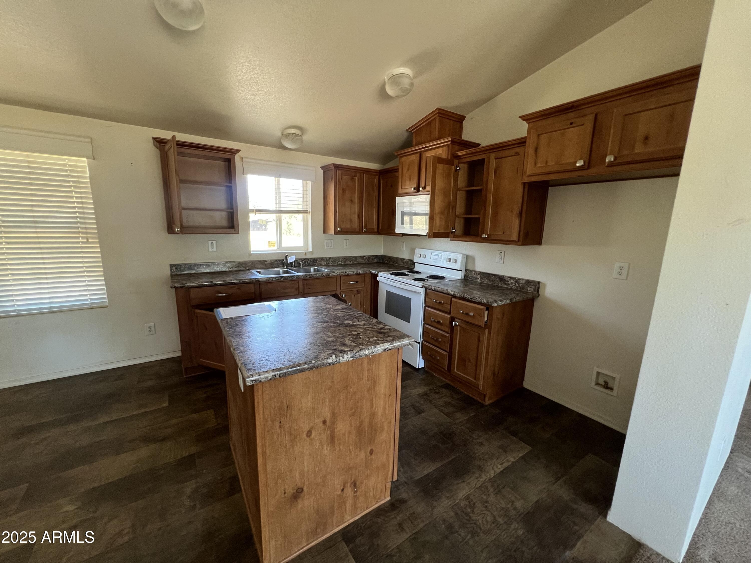 2122 Meadow Lane Overgaard, AZ 85933 - Photo 4 of 19 a kitchen with stainless steel appliances granite countertop a stove a sink and a microwave