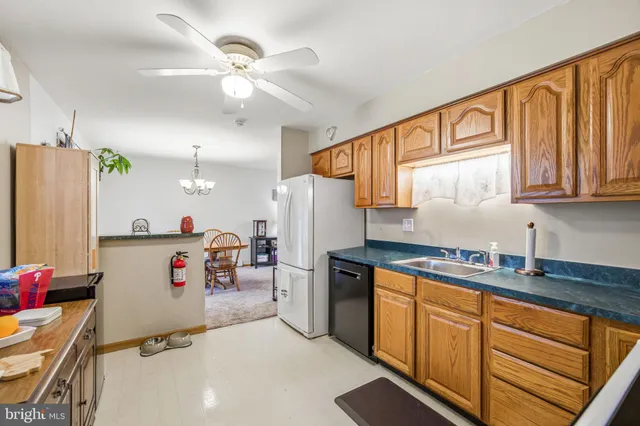 a kitchen with refrigerator and cabinets