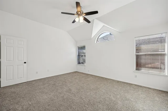 a view of empty room with ceiling fan