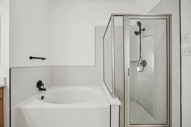 a bathroom with a tub and shower
