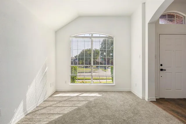 a view of an empty room with a window