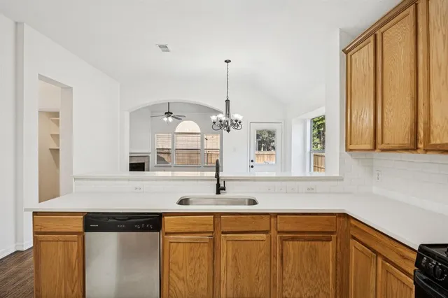 a kitchen with stainless steel appliances sink and cabinets
