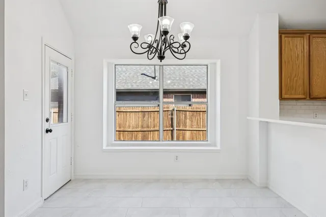 a view of a room that has a window and chandelier